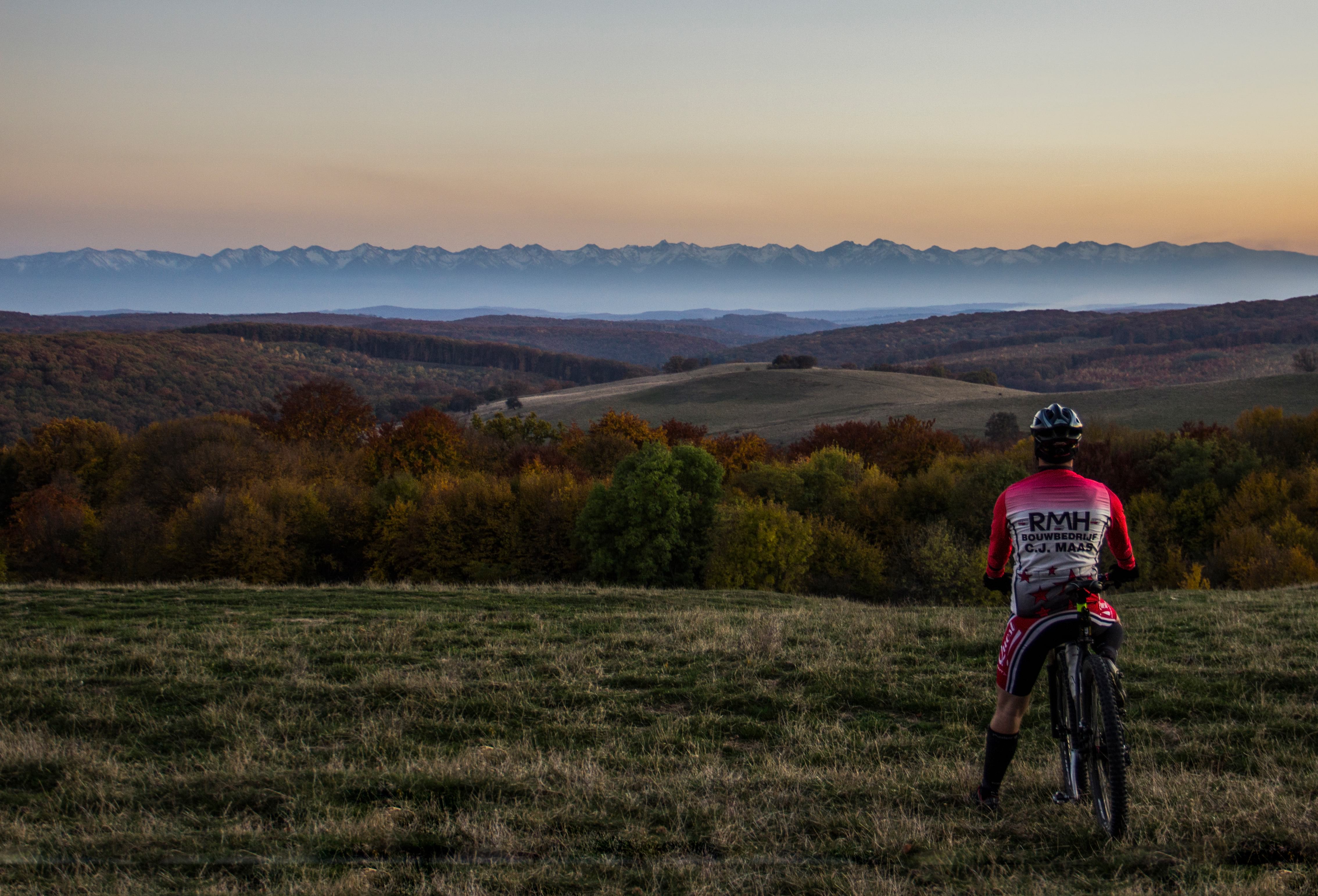 biker admiring the Fagaras ridge in the autumn sunset