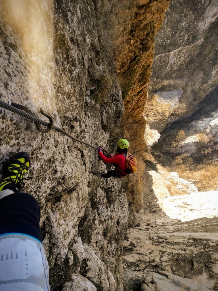 taking advantage of spring a couple is climbing the via ferrata in turzii gorges